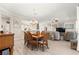 Open floor plan featuring a dining table, kitchen, and living room with neutral tones at 9120 Se 125Th Loop, Summerfield, FL 34491