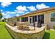 Outdoor patio featuring a stone surround fire pit with plenty of seating and grill area at 9120 Se 125Th Loop, Summerfield, FL 34491