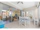 Bright sunroom with a white table, views of the backyard, and sliding glass doors at 9120 Se 125Th Loop, Summerfield, FL 34491