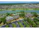 Aerial view showcasing community amenities including a pool and lake in a residential neighborhood at 9948 Sw 69Th Ln, Ocala, FL 34481