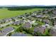 Aerial view showcases a well-planned neighborhood with green spaces and neatly arranged homes at 9948 Sw 69Th Ln, Ocala, FL 34481