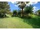 Lush backyard featuring a vibrant green lawn and mature landscaping surrounding the home at 9948 Sw 69Th Ln, Ocala, FL 34481