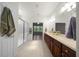Bathroom featuring double sinks, vanity with brown cabinets, and enclosed glass shower at 9948 Sw 69Th Ln, Ocala, FL 34481