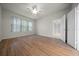 Spacious bedroom with hardwood floors, a ceiling fan, a window, and a closet at 9948 Sw 69Th Ln, Ocala, FL 34481