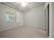 Bedroom with neutral carpet, a window with blinds, and a closet at 9948 Sw 69Th Ln, Ocala, FL 34481