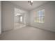 Bright and airy bedroom with neutral carpet, a ceiling fan, and a doorway leading to an adjoining room at 9948 Sw 69Th Ln, Ocala, FL 34481