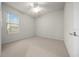 Bright bedroom featuring neutral carpet, a window, and a ceiling fan at 9948 Sw 69Th Ln, Ocala, FL 34481