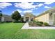 Charming single-story residence featuring manicured landscaping, a welcoming walkway, and a convenient two-car garage at 9948 Sw 69Th Ln, Ocala, FL 34481
