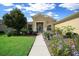 Lovely single-story home boasts lush front yard landscaping and a paved walkway to the entrance, inviting charm and curb appeal at 9948 Sw 69Th Ln, Ocala, FL 34481