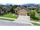 Well-maintained single-story home with a long driveway, a two-car garage, and verdant landscaping on a sunny day at 9948 Sw 69Th Ln, Ocala, FL 34481