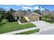 Charming single-story home featuring a well-manicured lawn, lush landscaping, and a spacious driveway leading to an attached garage at 9948 Sw 69Th Ln, Ocala, FL 34481