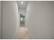 Hallway with tile flooring leading to a bedroom with natural light at 9948 Sw 69Th Ln, Ocala, FL 34481