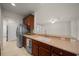 Kitchen with wood cabinets, stainless steel appliances, and breakfast bar at 9948 Sw 69Th Ln, Ocala, FL 34481