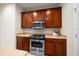 Close up of the kitchen, featuring stainless steel oven and microwave, and wood cabinets at 9948 Sw 69Th Ln, Ocala, FL 34481