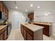 Eat-in kitchen features wood cabinetry, island, and stainless steel appliances at 9948 Sw 69Th Ln, Ocala, FL 34481