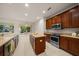 Well-lit kitchen featuring an island, stainless steel appliances, and ample wooden cabinetry for storage at 9948 Sw 69Th Ln, Ocala, FL 34481