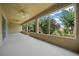 Enclosed lanai with multiple windows offering great views of the lush green lawn and landscaping at 9948 Sw 69Th Ln, Ocala, FL 34481