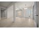 Bright living room with tile flooring, large windows, and elegant entryway at 9948 Sw 69Th Ln, Ocala, FL 34481