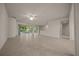 Spacious living room with tile flooring and sliding glass doors to lanai at 9948 Sw 69Th Ln, Ocala, FL 34481