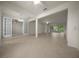 Open-concept living area with tiled floors, ceiling fans, decorative columns, and sliding glass doors to the outside at 9948 Sw 69Th Ln, Ocala, FL 34481