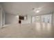 Open-concept living area with tile flooring, neutral walls, and access to the kitchen at 9948 Sw 69Th Ln, Ocala, FL 34481