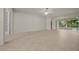 Open living room with tile floors, ceiling fan, and sliding glass door to the lanai at 9948 Sw 69Th Ln, Ocala, FL 34481