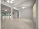 Spacious living room featuring tile floors, an open floor plan, and natural light from large windows at 9948 Sw 69Th Ln, Ocala, FL 34481