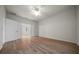 Primary bedroom with hardwood floors, ceiling fan, and ensuite bathroom access at 9948 Sw 69Th Ln, Ocala, FL 34481