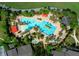 Bird's eye view of a resort style pool surrounded by lounge seating and landscaped gardens at 9948 Sw 69Th Ln, Ocala, FL 34481
