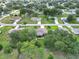 An aerial view highlights the lush greenery of the neighborhood and the well-maintained lawns surrounding the home at 10086 Sw 62Nd Terrace Rd, Ocala, FL 34476