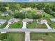 This aerial view captures the home's inviting curb appeal within a tranquil, green residential neighborhood at 10086 Sw 62Nd Terrace Rd, Ocala, FL 34476