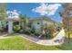 This backyard features a well-manicured lawn, beautiful garden and a brick path, perfect for outdoor living at 10086 Sw 62Nd Terrace Rd, Ocala, FL 34476