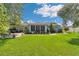 Expansive backyard offers a brick patio, large grassy area, and mature trees, ideal for entertaining and recreation at 10086 Sw 62Nd Terrace Rd, Ocala, FL 34476