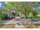 Lush backyard boasts a paved patio with seating, firepit, and a sprawling lawn, ideal for outdoor enjoyment at 10086 Sw 62Nd Terrace Rd, Ocala, FL 34476