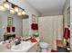 Well-lit bathroom features a neutral color scheme, decorative accents, and modern vanity with neutral countertops at 10086 Sw 62Nd Terrace Rd, Ocala, FL 34476