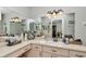 Bathroom with vanity, sink, a large mirror, and decorative lighting and accessories at 10086 Sw 62Nd Terrace Rd, Ocala, FL 34476