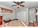 Bedroom featuring a ceiling fan, wood-look floors, closet, and white-painted walls at 10086 Sw 62Nd Terrace Rd, Ocala, FL 34476