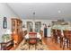 Bright dining room with hardwood floors and adjacent kitchen with bar seating at 10086 Sw 62Nd Terrace Rd, Ocala, FL 34476