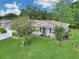 An aerial shot showcasing the house with its well-kept lawn, beautiful landscaping, and a peaceful neighborhood setting at 10086 Sw 62Nd Terrace Rd, Ocala, FL 34476