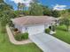 Aerial image of the home showcasing its clean white exterior, attached garage, and meticulously landscaped surroundings at 10086 Sw 62Nd Terrace Rd, Ocala, FL 34476