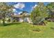 A charming house with neatly manicured lawn, vibrant landscaping, and an inviting facade with great curb appeal at 10086 Sw 62Nd Terrace Rd, Ocala, FL 34476
