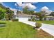Charming front exterior featuring a well-manicured lawn, long driveway and a two-car garage at 10086 Sw 62Nd Terrace Rd, Ocala, FL 34476