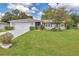 Charming single-story home featuring a well-manicured lawn and inviting curb appeal at 10086 Sw 62Nd Terrace Rd, Ocala, FL 34476