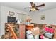 Cozy living room featuring ample storage, a ceiling fan, and a comfortable sofa for relaxation and entertainment at 10086 Sw 62Nd Terrace Rd, Ocala, FL 34476