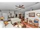 Comfortable living room showing hardwood floors, a ceiling fan, and access to dining area at 10086 Sw 62Nd Terrace Rd, Ocala, FL 34476
