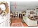 Open-concept living space with hardwood floors and seamless flow to the dining area at 10086 Sw 62Nd Terrace Rd, Ocala, FL 34476