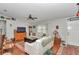 Spacious living room with hardwood flooring, a comfortable seating arrangement and lots of light at 10086 Sw 62Nd Terrace Rd, Ocala, FL 34476