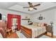 Well-lit main bedroom features a ceiling fan, wood-look floors, and neutral wall paint at 10086 Sw 62Nd Terrace Rd, Ocala, FL 34476