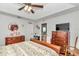 Bright bedroom with a ceiling fan, wood-look floors, ensuite bathroom, and walk-in closet at 10086 Sw 62Nd Terrace Rd, Ocala, FL 34476