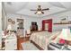 Spacious main bedroom with a tray ceiling, ensuite bathroom, and wood-look flooring at 10086 Sw 62Nd Terrace Rd, Ocala, FL 34476